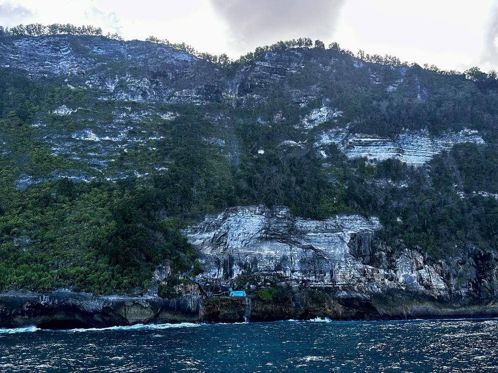 The Peguyangan cliff and blue staircase, with the blue water tank at the bottom that gathers spring water, Nusa Penida