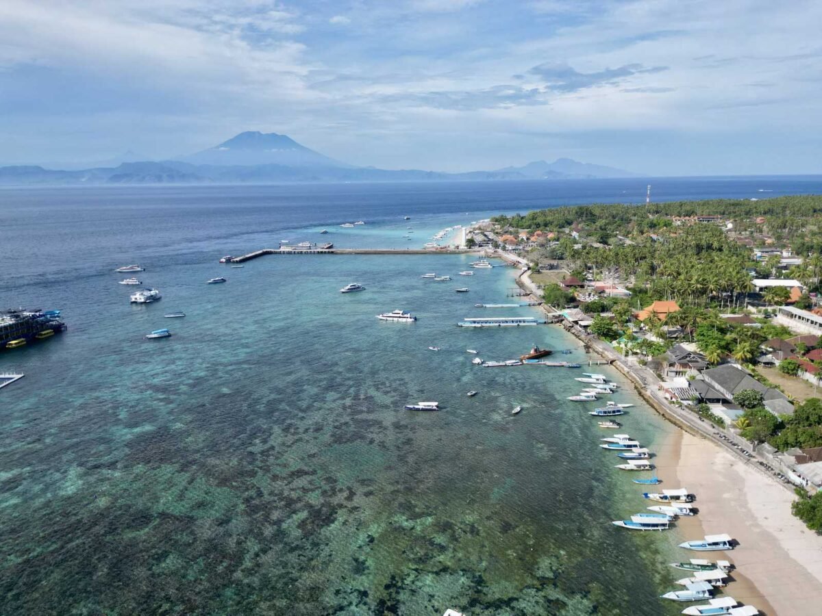 Aerial drone view of Toyapakeh on Nusa Penida: the boat moorings on the right, the snorkelling-boat jetty in the middle and the beach for dive and Nusa Lembongan boats on the left