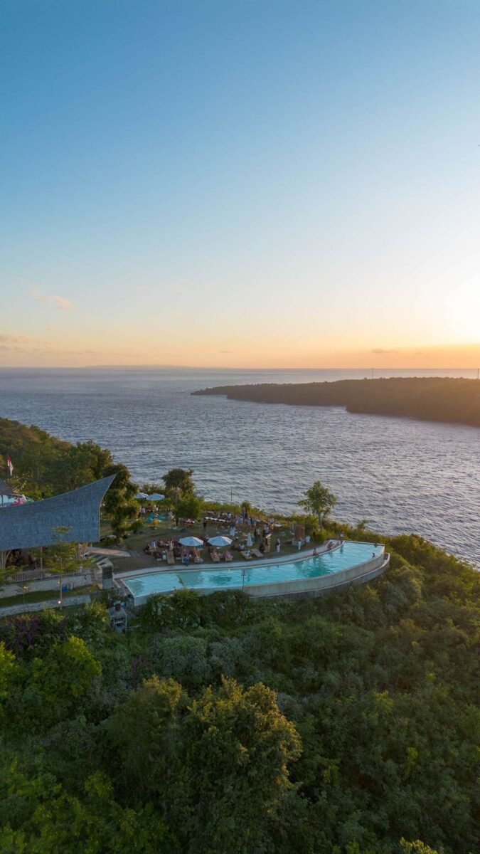 Golden sunset over Amok Sun & Cliff Club seen from the air, Nusa Penida