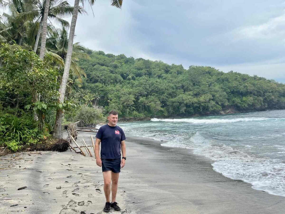 Blaise standing on a completely empty Gamat Bay beach in 2022, before any building, Nusa Penida