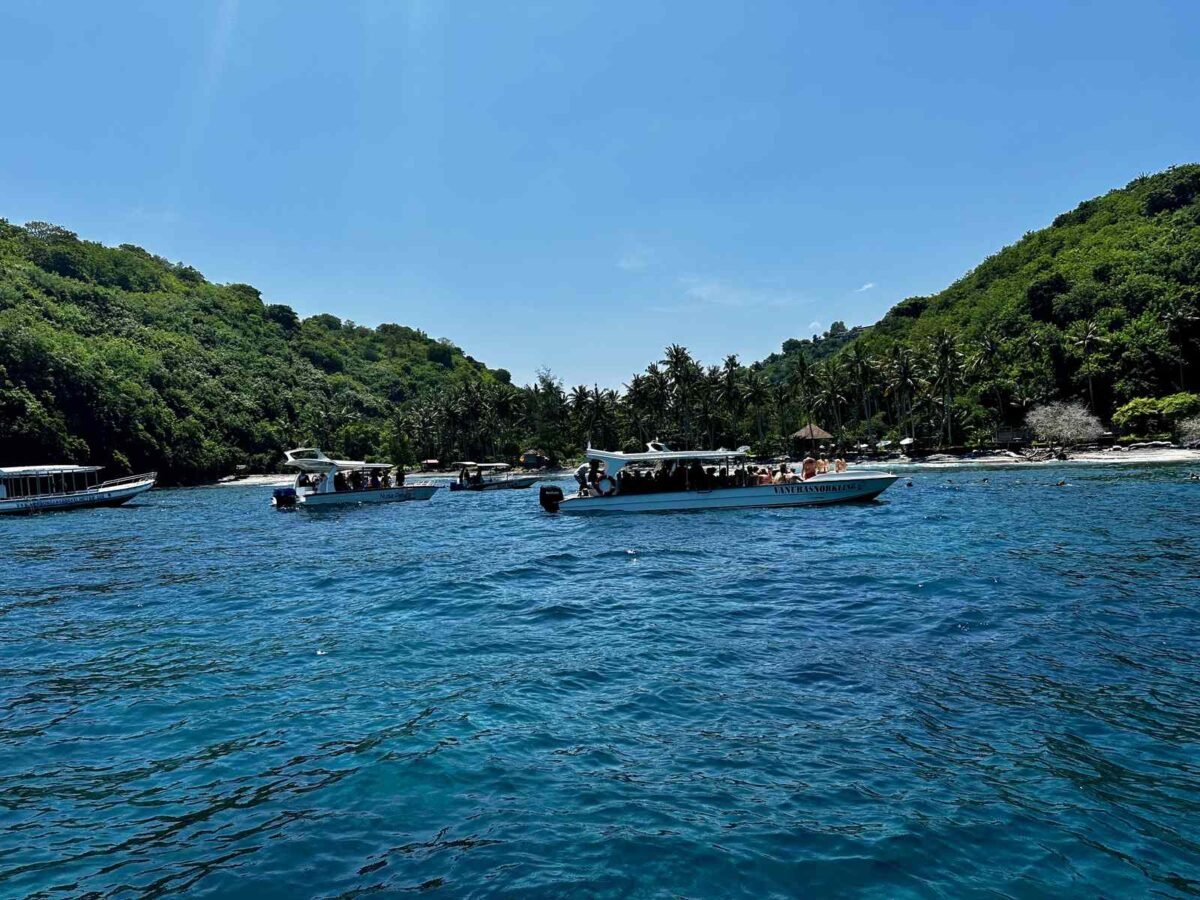 Gamat Bay seen from the sea in March 2024 with the first small warung on the beach, Nusa Penida