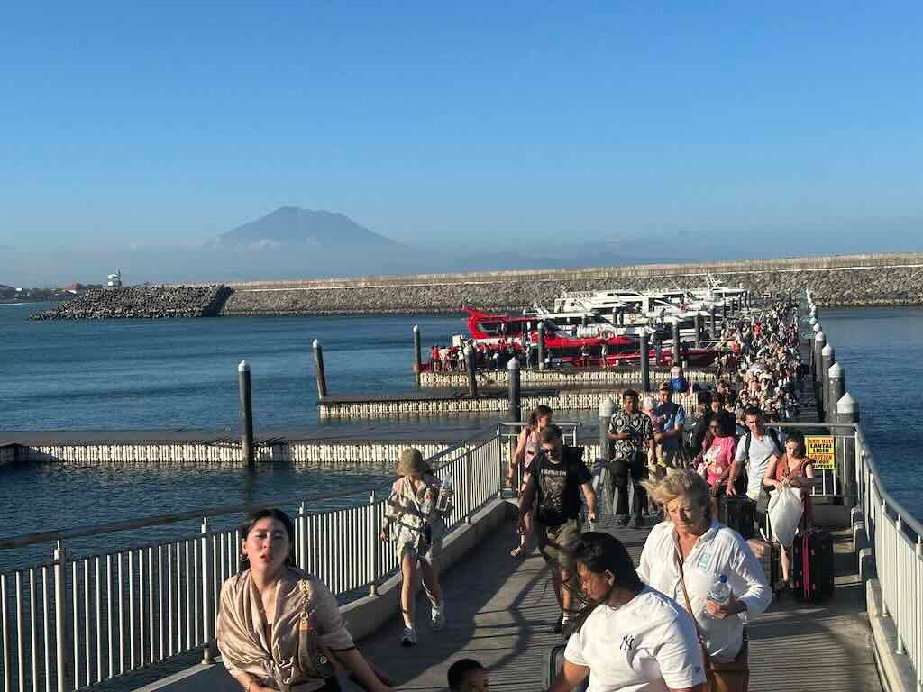 Crowded Sanur fast boat terminal with passengers queuing for Nusa Penida