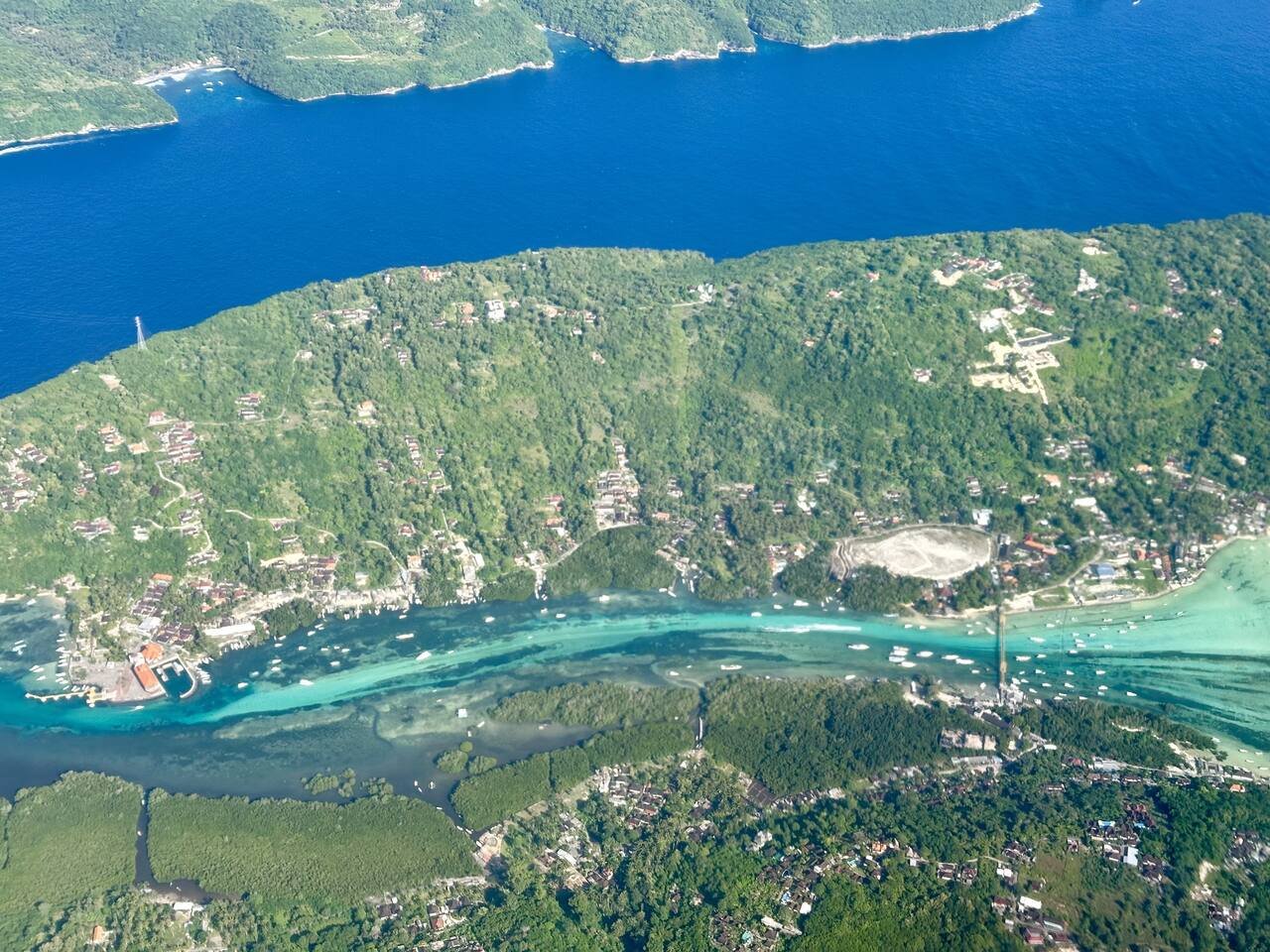 Aerial view of Nusa Lembongan and Nusa Ceningan with turquoise channels and seaweed farms
