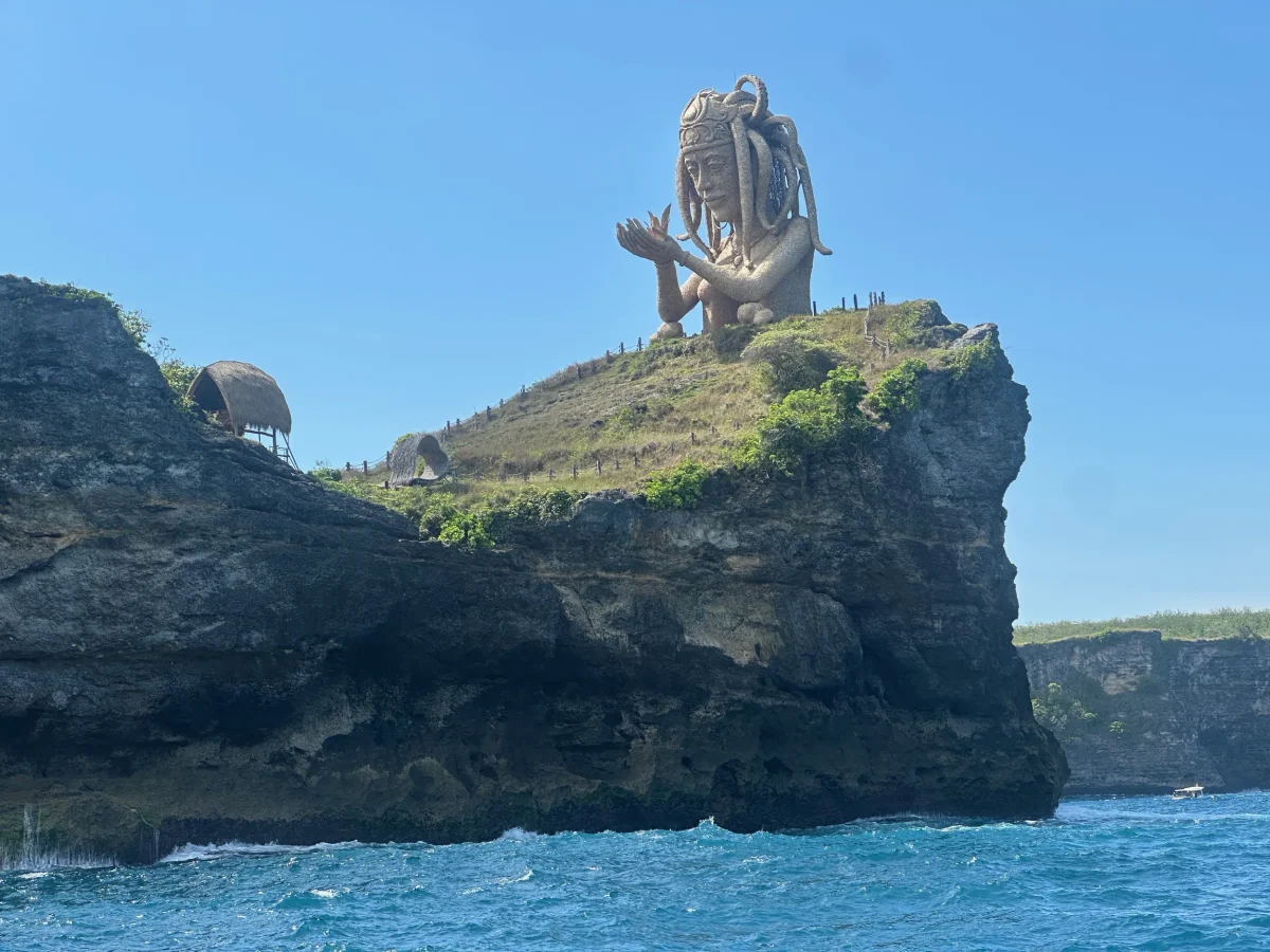 The Octopus Queen woven-bamboo sculpture on the headland near Broken Beach, seen from the sea, Nusa Penida