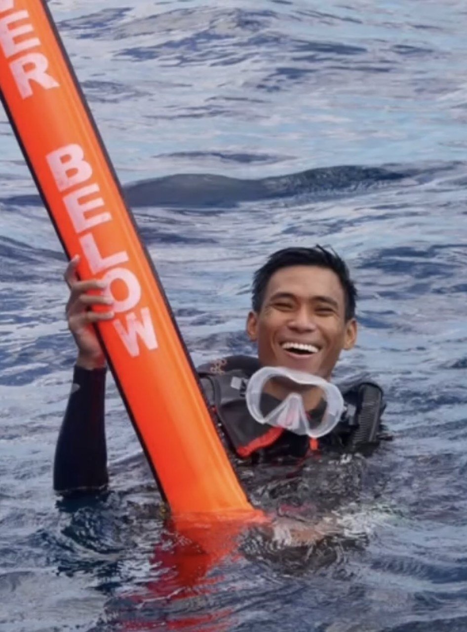 Roy, dive instructor at Dune Penida, at the surface with a diver-below SMB buoy, Nusa Penida
