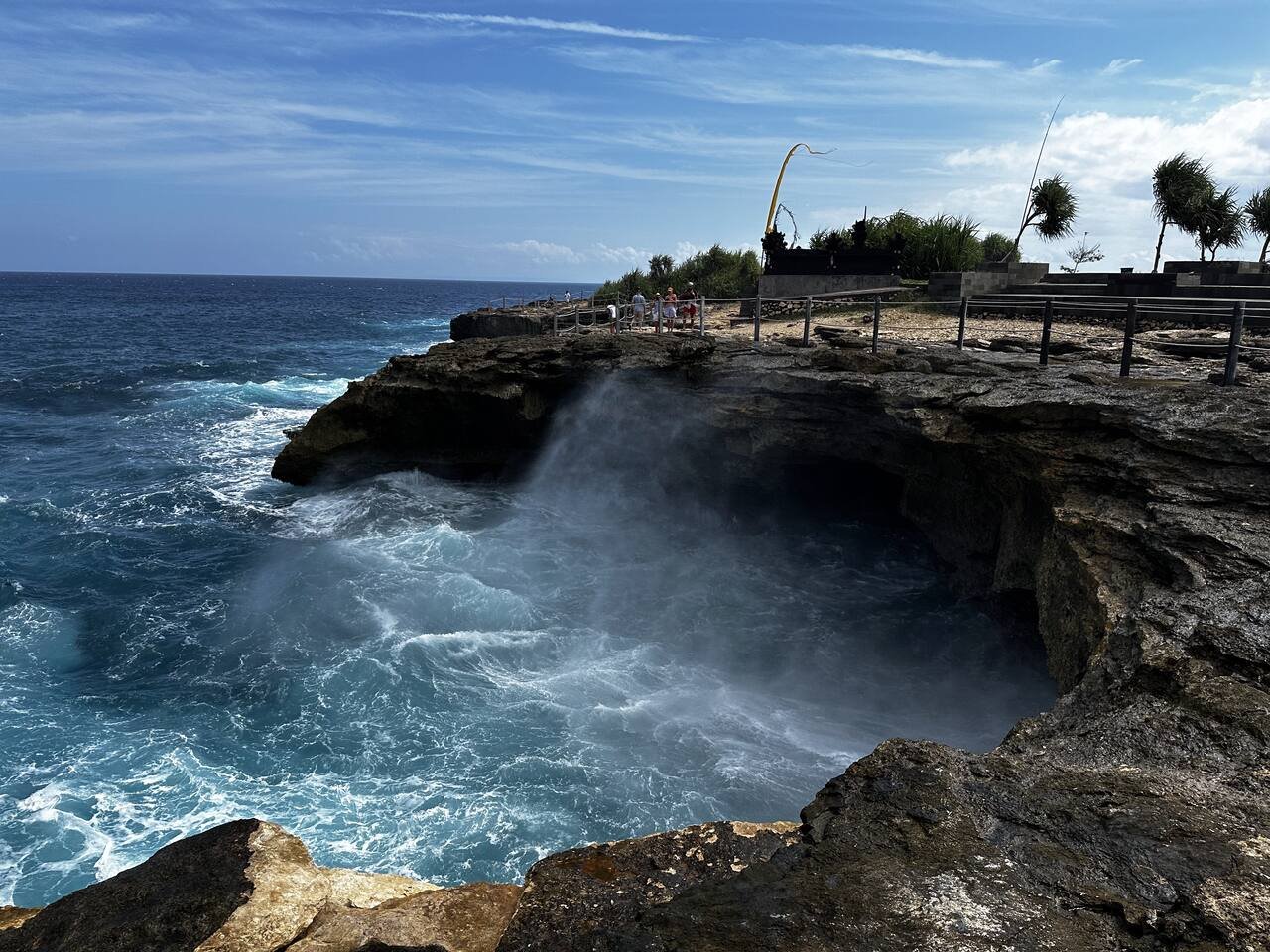 Rocky coastline and breaking waves near Sandy Bay on the west coast of Nusa Lembongan
