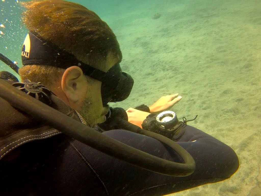 Diver checking the compass on the underwater navigation dive in Nusa Penida